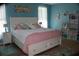 Spacious bedroom features blue walls, a large white bed, and ample natural light at 207 Short Woods Ct, Summerville, SC 29486