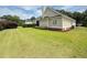 A lawn featuring a view of the screened-in porch and manicured bushes and green grass at 213 Ashmont Dr, Wando, SC 29492