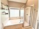 Bright bathroom features a soaking tub, separate glass enclosed shower, and glass display shelves at 213 Ashmont Dr, Wando, SC 29492