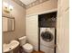 The bathroom features a washer and dryer closet, a toilet, and a sink at 213 Ashmont Dr, Wando, SC 29492