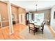 Elegant dining room with hardwood floors and a view to the foyer and the living room at 213 Ashmont Dr, Wando, SC 29492