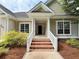 Welcoming entrance with brick steps, white railing, and a covered porch offering curb appeal at 213 Ashmont Dr, Wando, SC 29492
