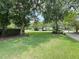 Beautifully landscaped front yard with lush green grass and mature trees at 213 Ashmont Dr, Wando, SC 29492
