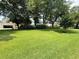 Expansive green lawn with mature trees, shrubs, and manicured landscape at 213 Ashmont Dr, Wando, SC 29492