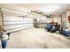 Spacious garage with a white door, a riding mower, and ample storage at 213 Ashmont Dr, Wando, SC 29492