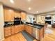 Well-lit kitchen featuring wood cabinets, stainless steel appliances and a breakfast bar open to the living area at 213 Ashmont Dr, Wando, SC 29492