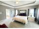 Spacious main bedroom featuring a tray ceiling, carpet flooring, natural light, and ensuite bathroom access at 213 Ashmont Dr, Wando, SC 29492
