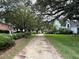 Scenic neighborhood path lined with mature trees and lush landscaping at 213 Ashmont Dr, Wando, SC 29492