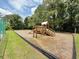 Community playground with a wooden playset, slide, and swings at 213 Ashmont Dr, Wando, SC 29492