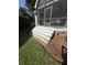 Stairway to the screened-in porch, featuring brick details and a security system sign at 213 Ashmont Dr, Wando, SC 29492