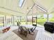 Spacious screened-in porch with a ceiling fan, skylights, and an outdoor dining set at 213 Ashmont Dr, Wando, SC 29492