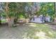 Backyard featuring additional outbuilding for storage, hobbies, or potential conversion, all set in a grassy, tree-lined yard at 2215 Suffolk St, North Charleston, SC 29405