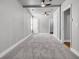 Spacious bedroom with gray walls, neutral carpet, ceiling fan and multiple doorways at 2215 Suffolk St, North Charleston, SC 29405