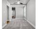 Bright bedroom with neutral walls, plush carpeting, ceiling fan and natural light from window at 2215 Suffolk St, North Charleston, SC 29405