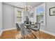 Dining room with glass table, seating for four, and a unique chandelier above at 2215 Suffolk St, North Charleston, SC 29405