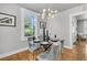 Well-lit dining area with a glass table, seating for four, and a modern light fixture at 2215 Suffolk St, North Charleston, SC 29405