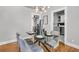 Formal dining room with glass table, seating for four, and contemporary chandelier at 2215 Suffolk St, North Charleston, SC 29405