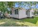 Classic home featuring vinyl siding and shuttered windows, complemented by blossoming trees for added beauty and charm at 2215 Suffolk St, North Charleston, SC 29405