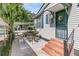 Covered outdoor patio showing access to the home with a small table and seating at 2215 Suffolk St, North Charleston, SC 29405