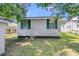 Classic home featuring vinyl siding and shuttered windows, set against a beautiful blue sky at 2215 Suffolk St, North Charleston, SC 29405