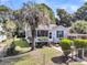 Inviting single-story home featuring a lush front yard with mature palm trees and a classic fenced perimeter at 2215 Suffolk St, North Charleston, SC 29405