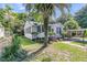 Landscaped front yard with mature palm trees and covered carport offering a tranquil outdoor living space at 2215 Suffolk St, North Charleston, SC 29405