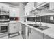 Bright kitchen boasts stainless steel appliances, white countertops, and tile backsplash at 2215 Suffolk St, North Charleston, SC 29405