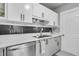 Well-lit kitchen with stainless steel appliances, white countertops and custom backsplash at 2215 Suffolk St, North Charleston, SC 29405