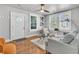 Bright living room with hardwood floors, large windows, and a modern ceiling fan for comfortable living at 2215 Suffolk St, North Charleston, SC 29405
