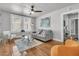 Bright living room features hardwood floors, modern furniture and decor, and a ceiling fan at 2215 Suffolk St, North Charleston, SC 29405