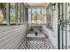 Relaxing screened-in porch with cozy seating, offering a perfect spot to enjoy the outdoors in comfort at 2215 Suffolk St, North Charleston, SC 29405