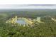 Aerial view of community with many trees and winding ponds at 233 Camber Rd, Huger, SC 29450