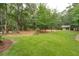 Expansive backyard with lush green grass and a shed provides ample space for outdoor activities at 233 Camber Rd, Huger, SC 29450