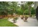 Spacious backyard with seating, a fire pit, and lush greenery, perfect for outdoor entertaining and relaxation at 233 Camber Rd, Huger, SC 29450