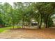 Spacious backyard featuring mature trees and a well-manicured lawn for outdoor enjoyment at 233 Camber Rd, Huger, SC 29450