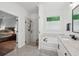 Bright bathroom featuring a separate glass shower, a soaking tub, and a view to the bedroom providing a luxurious retreat at 233 Camber Rd, Huger, SC 29450
