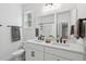 Bright bathroom with double vanity, white cabinets, granite countertops, and tile floors at 233 Camber Rd, Huger, SC 29450