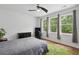 Bright bedroom with three large windows, ceiling fan, green rug, wood floors and neutral walls at 233 Camber Rd, Huger, SC 29450