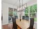Bright dining room features a modern light fixture and sliding glass door to the patio at 233 Camber Rd, Huger, SC 29450