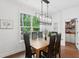 Bright dining room features a modern light fixture and view to the backyard at 233 Camber Rd, Huger, SC 29450