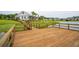 Wooden dock overlooks a scenic lake and landscaping, providing tranquil views at 233 Camber Rd, Huger, SC 29450