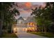 Inviting two-story home with a charming front porch and well-maintained landscaping, offering curb appeal at 233 Camber Rd, Huger, SC 29450