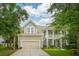 Charming two-story home with well-manicured lawn, two-car garage and covered porch at 233 Camber Rd, Huger, SC 29450