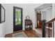 Charming foyer with hardwood floors, vintage secretary and glass paneled front door at 233 Camber Rd, Huger, SC 29450