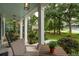 Inviting front porch with view of beautifully landscaped yard and rocking chairs at 233 Camber Rd, Huger, SC 29450