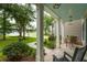 Inviting front porch with peaceful view of lake, hammock, and mature trees at 233 Camber Rd, Huger, SC 29450