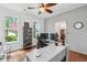 Well-lit home office featuring hardwood floors and shiplap accent wall at 233 Camber Rd, Huger, SC 29450