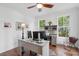 Bright home office with dual windows, hardwood floors, and ample desk space at 233 Camber Rd, Huger, SC 29450