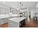 Kitchen with island that includes bar stool seating, stainless steel appliances and modern lighting at 233 Camber Rd, Huger, SC 29450