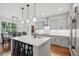 Charming kitchen featuring stainless steel appliances, island with breakfast bar and pendant lighting at 233 Camber Rd, Huger, SC 29450
